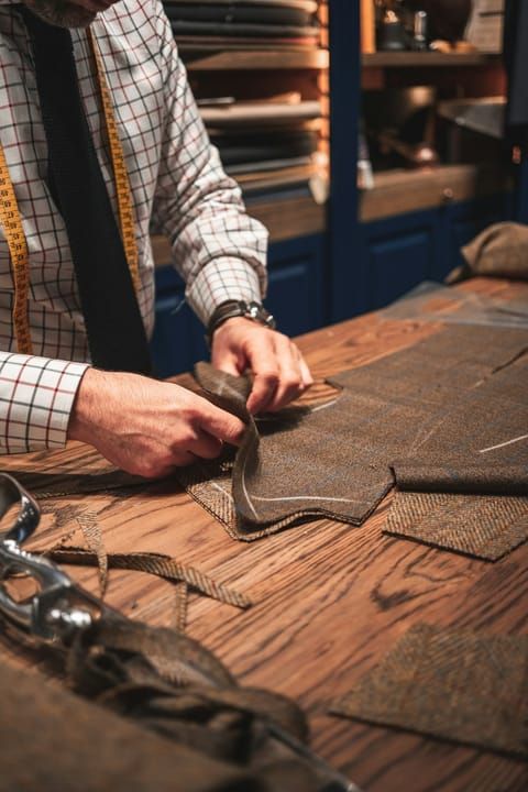 A master tailor cutting fabric
