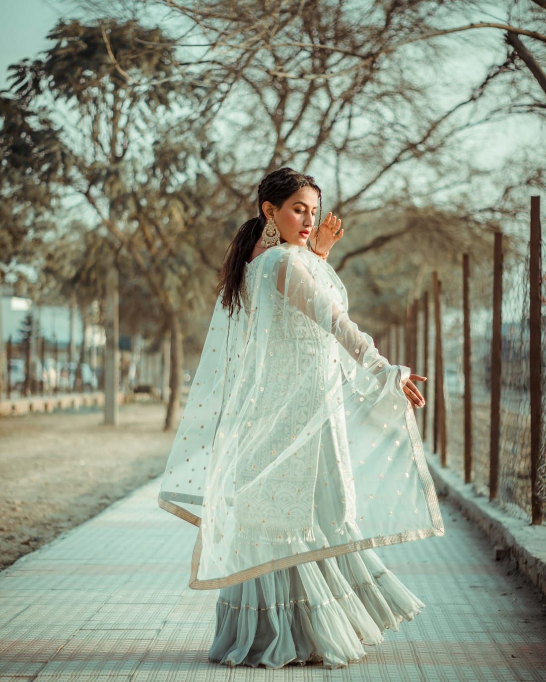 A woman in white embroidered Indian ethnic wear